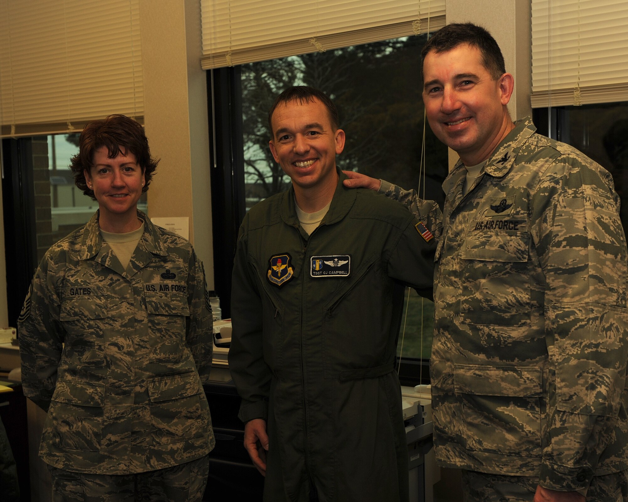 Tech. Sgt. CJ Campbell (center), a 314th Operations Group standardization and evaluation loadmaster, is recognized as the Combat Airlifter of the Week by Col. Todd Pavich (right), 314th Airlift Wing vice commander, and Chief Master Sgt. Andrea Gates (left), 314th AW command chief master sergeant on Feb. 25, 2013, at Little Rock Air Force Base, Ark. Campbell is responsible for the standardization of policies and procedures for 90 instructor and evaluator loadmasters in the Department of Defense's largest C-130 Formal Training Unit. (U.S. Air Force photo by Airman Scott Poe)