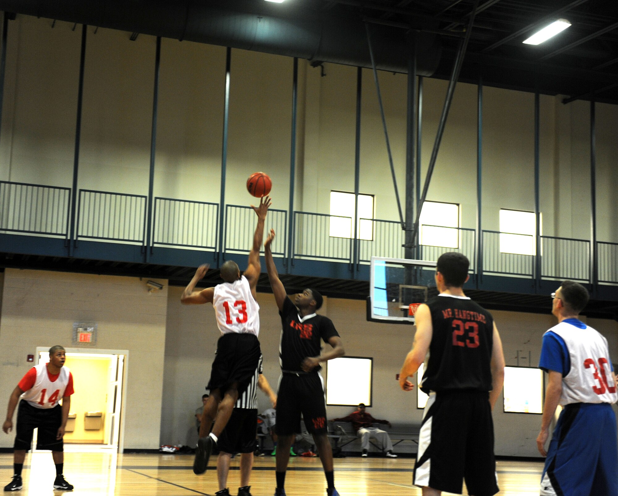The 19th Communications Squadron and the 19th Logistics Readiness Squadron teams tip off at the beginning of the game March 5, 2013, at Little Rock Air Force Base, Ark. There are a total of 14 intramural basketball teams on the base. (U.S Air Force photo by Staff Sgt. Jessica Condit)