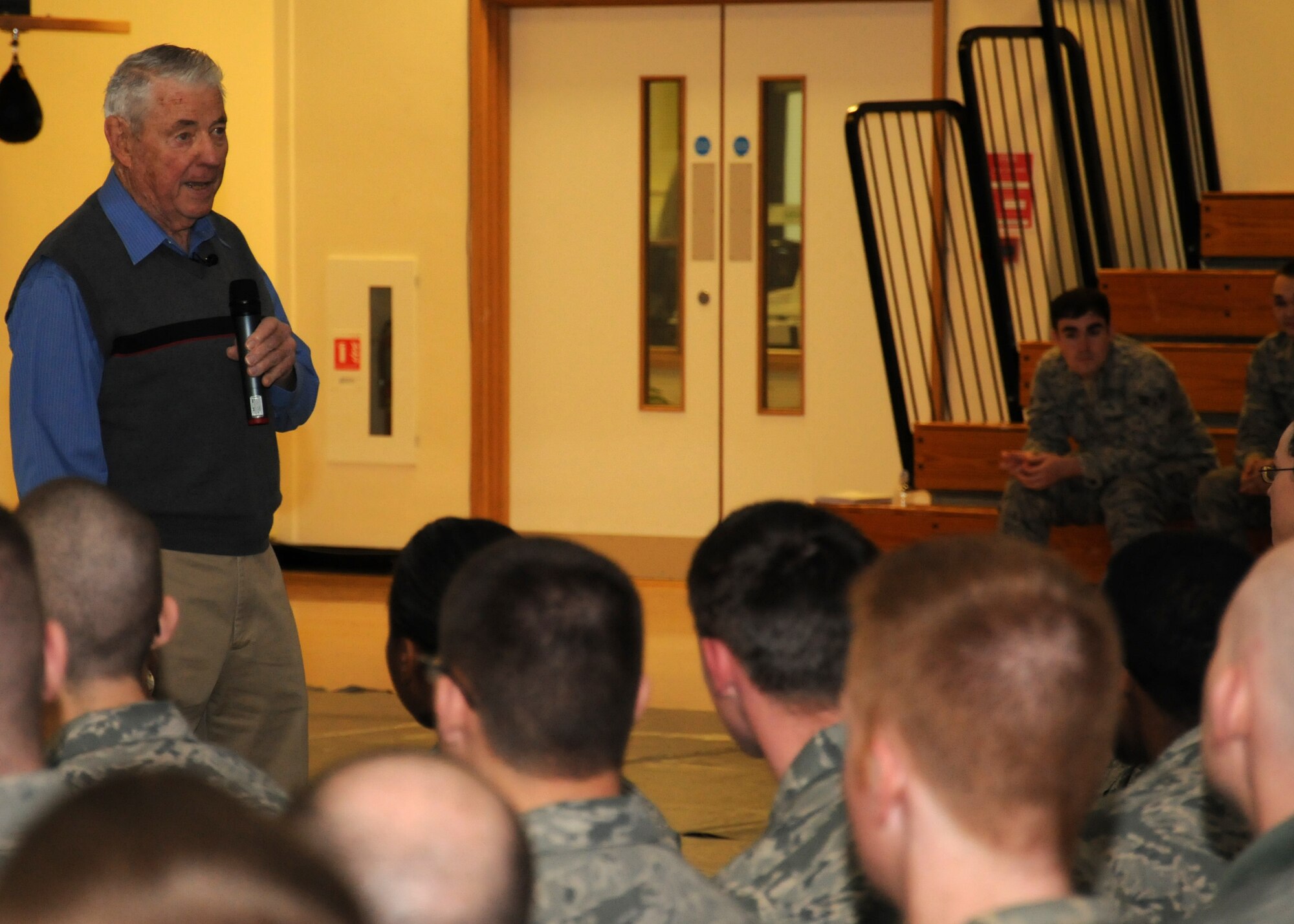 Retired Chief Master Sgt. of the Air Force Bob Gaylor, fifth CMSAF, shares his memories and experiences of his time serving in the U.S. Air Force with Airmen currently serving during an enlisted call March 6, 2013, at the Hardstand Fitness Center, RAF Mildenhall, England. Gaylor spoke about the "four Ts": Training, Tribe, Technology and Trust. He reflected on how they applied back in his Air Force time and still apply in the Air Force of today. (U.S. Air Force photo by Airman 1st Class Dillon Johnston/Released)