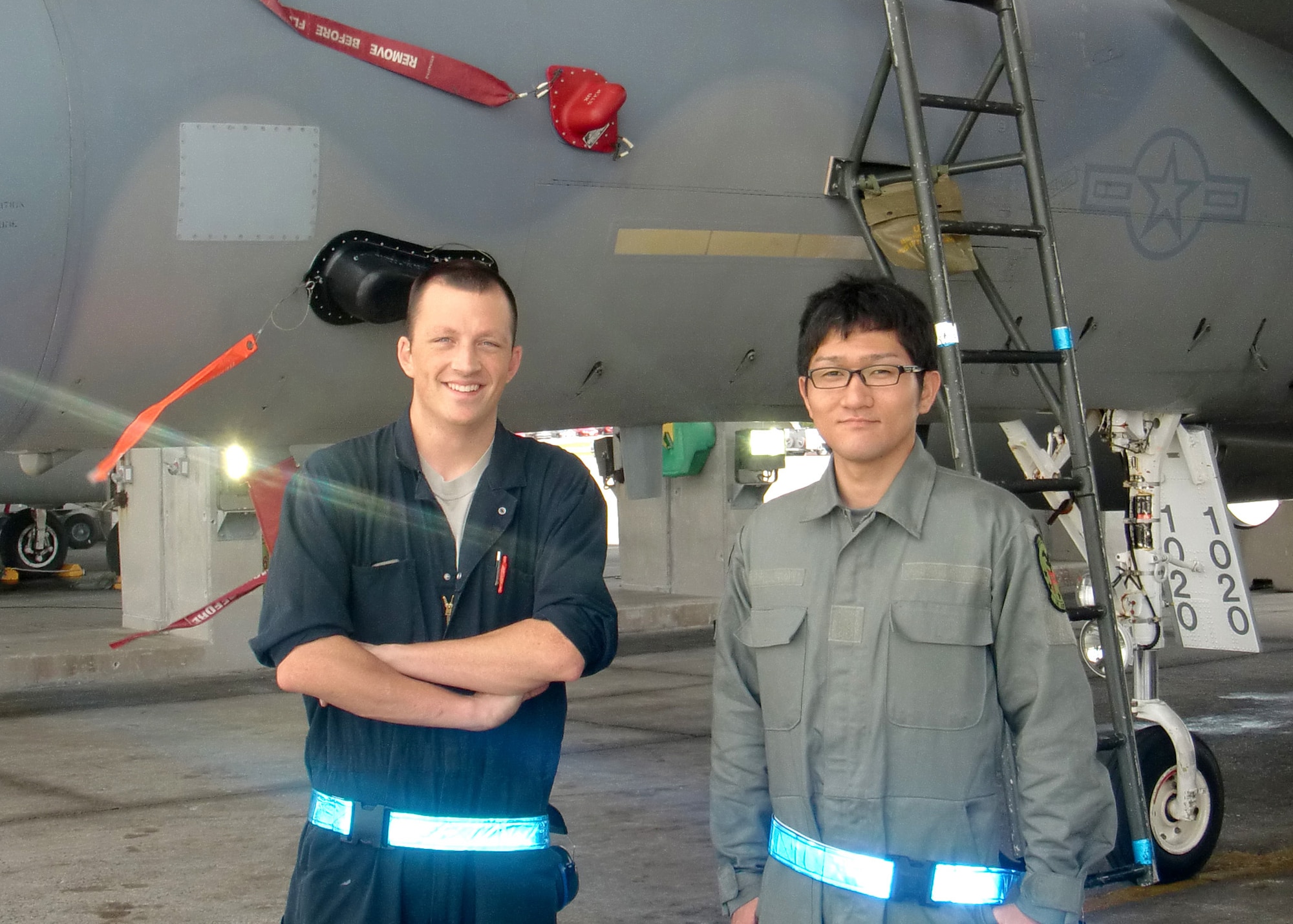 U.S. Air Force Staff Sgt. Aaron Martin, from the 18th Aircraft Maintenance Squadron, and Japan Air Self Defense Force Staff Sgt. Shoei Uehata pose for a picture on Kadena Air Base, Japan. The 2013 JASDF NCO Bilateral Exchange paired eight Kadena NCOs with eight JASDF NCOs from similar career fields for about 10 days. (U.S. Air Force photo/Staff Sgt. Marcos Flores)