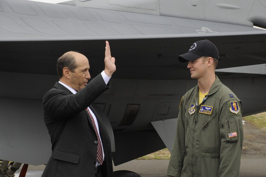 Ambassador Jeffrey Bleich, U.S. Ambassador to Australia, talks to U.S. Air Force Capt. Ryan Worrell, Pacific Air Forces demonstration team pilot, about an aerial demonstration during the Australian International Airshow 2013, at Avalon Airport, Australia, Feb. 27. The air show presented a unique opportunity for the United States to strengthen its military relations with various country representatives. (U.S. Air Force photo by Airman 1st Class Kenna Jackson)