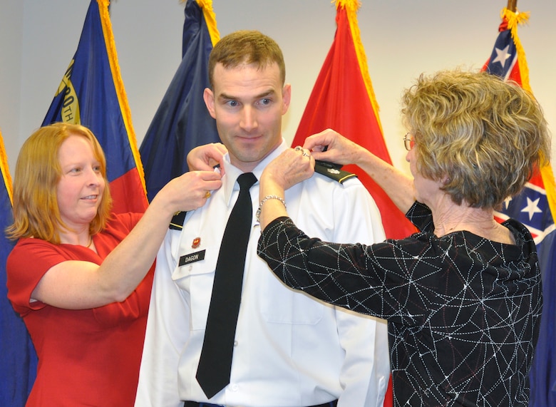 U.S. Army Corps of Engineers Nashville District Deputy District Commander Lt. Col. Patrick Dagon, (center) from Butler, Ill., gets his shoulder boards placed on by his wife, Emily (left) and his mother, Myra (right) during a promotion ceremony March 8, 2013, at the U.S. Army Corps of Engineers Nashville District Headquarters, in Nashville, Tenn. Dagon has been with the Nashville District since Aug 2011. His next assignment is with the Defense Threat Reduction Agency at Kirtland Air Force Base, Albuquerque, N.M., with a report date in August. (USACE photo by Mark Rankin)