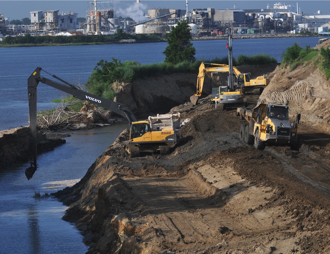 Construction takes place for a rock revetment and dike raising project at Savannah Harbor dredge disposal areas, managed by the U.S. Army Corps of Engineers.