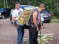 Volunteers from Marine Wing Support Squadron 471 reconstruct the 54-foot Encampment River Bridge from scratch at the Superior Hiking Trail Sept. 7. The structure was washed away during a flood earlier that summer.