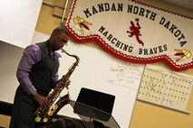 Gunnery Sgt. Jason Knuckles, 9th Marine Corps District Marine band placement director, serenades a class at Mandan High School March 7. Knuckles visited several high schools in North Dakota that week to perform and talk about the Marine music program.