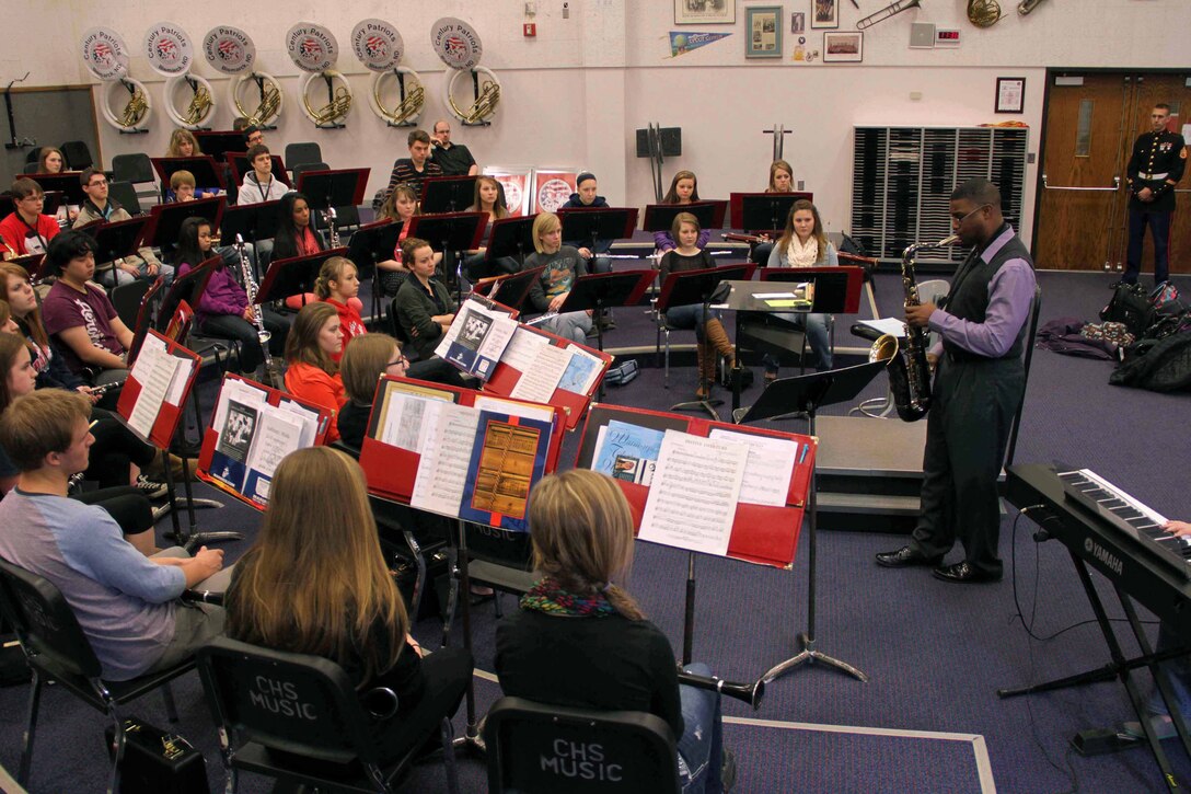 Gunnery Sgt. Jason Knuckles, 9th Marine Corps District Marine band placement director, serenades a group of musicians at Century High School March 7. Knuckles visited several high schools in North Dakota that week to perform and talk about the Marine music program.