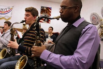 Gunnery Sgt. Jason Knuckles, 9th Marine Corps District Marine band placement director, performs with several Century High School musicians March 7. Knuckles visited several high schools in North Dakota that week to perform and talk about the Marine music program.