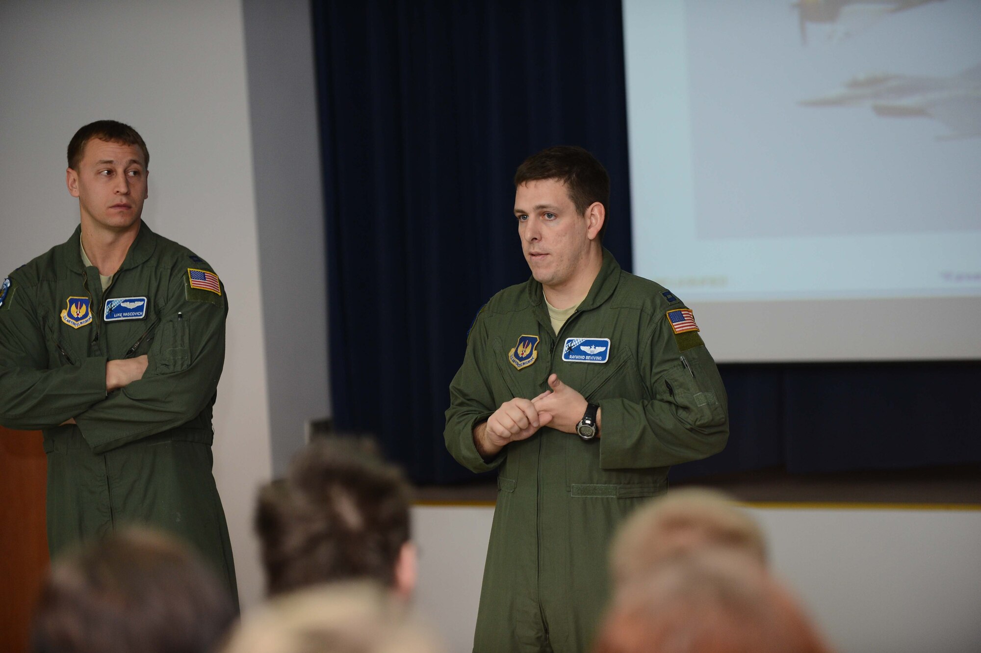 POWIDZ AIR BASE, Poland — U.S. Air Force Capt. Raymond Bevvino (right) and Capt. Luke Waschovich (left), pilots with the 37th Airlift Squadron, Ramstein Air Base, Germany, deliver a brief to secondary students from a local school district during a community outreach day at Powidz Air Base, Poland, March 8, 2013. Bevvino and Waschovich were in Poland participating in Exercise Screaming Eagle V, a bilateral exercise hosted by Aviation Detachment 1, 52nd Operations Group, Lask Air Base, Poland. (U.S. Air Force photo/Tech. Sgt. Kenya Shiloh)(released)
