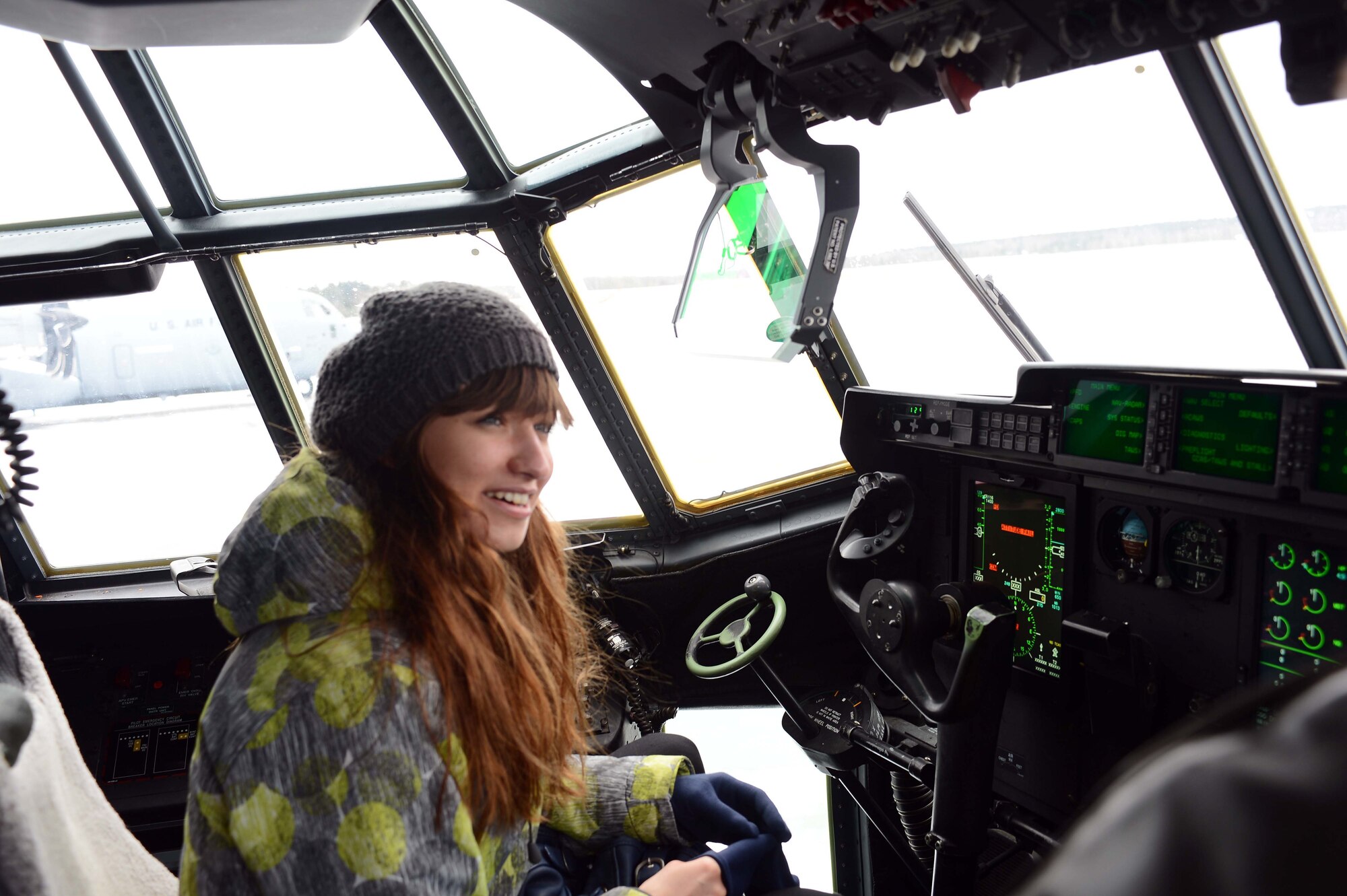 POWIDZ AIR BASE, Poland — Jagoda Lanka, a secondary school student from Zespol Szkol Technical High School sits in the cockpit of a C-130J Super Hercules during community outreach day at Powidz Air Base, Poland, March 8, 2013. Lanka, along with more than 100 students, toured the aircraft and learned about its features from Airmen assigned to the 37th Airlift Squadron, Ramstein Air Base, Germany. The 37th sent a group of nearly 60 personnel to Poland to promote partnership and air operability with Poland.   (U.S. Air Force photo/Tech. Sgt. Kenya Shiloh) (released)