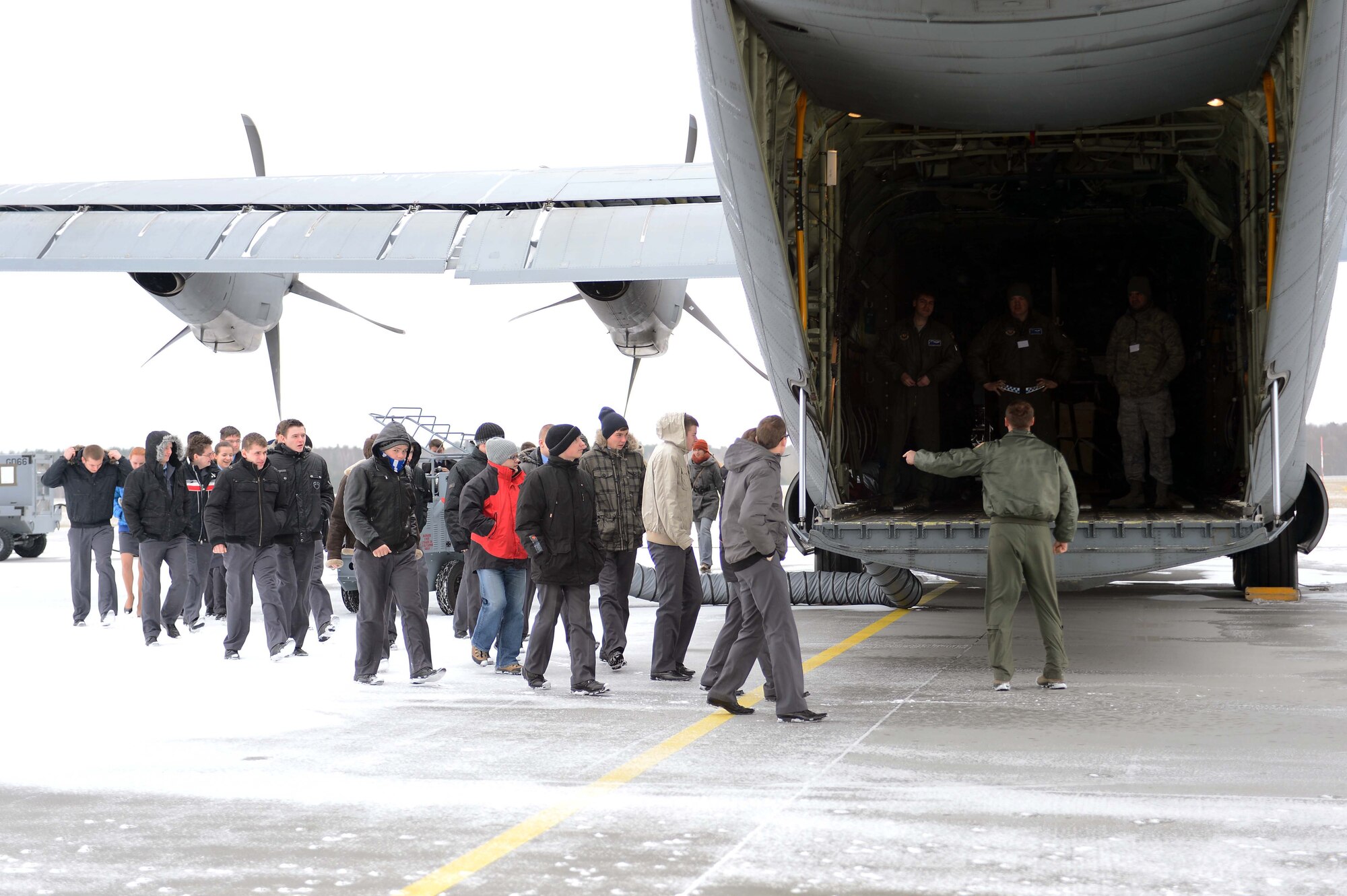POWIDZ AIR BASE, Poland — Students from Zespol school district prepare to board a C-130J Super Hercules March 8, 2013. More than 100 secondary school students from the Zespol school district visited Powidz Air Base, Poland, as part of a community outreach day. Members of the 37th Airlift Squadron were in Poland participating in Exercise Screaming Eagle V, a multi-national exercise hosted by Aviation Detachment 1, 52nd Operations Group, Lask Air Base, Poland, in  support of NATO Article 5 promoting the United States' enduring partnership with Poland. (U.S. Air Force photo/Tech. Sgt. Kenya Shiloh)(released)