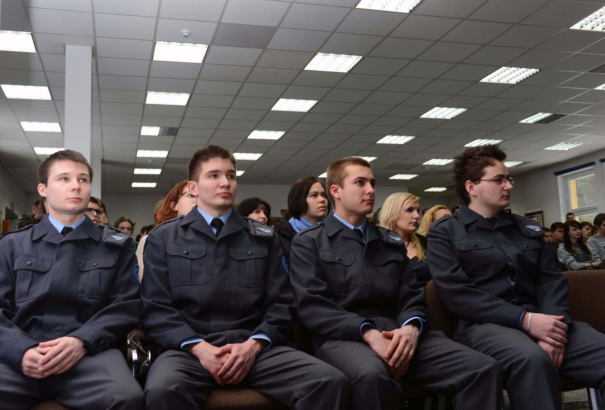POWIDZ AIR BASE, Poland —From left to right, Aleksander Lewandowski, Jan Matkowski, Mariusz Przybylski and Nowicki Dawid, students at the Zespol Sakol Technical Air School, receive a U.S. Air Force familiarization brief during community outreach day, March 8, 2013. The 37th AS began training in Poland nearly two weeks ago as part of Exercise Screaming Eagle V, a U.S.-Polish bilateral exercise sponsored by Aviation Detachment 1, 52nd Operations Group, Lask Air Base, Poland. This is the first of four quarterly rotations of U.S. military personnel in Poland building partnership capacity between the United States and Poland. (U.S. Air Force photo/Tech. Sgt. Kenya Shiloh)(released)