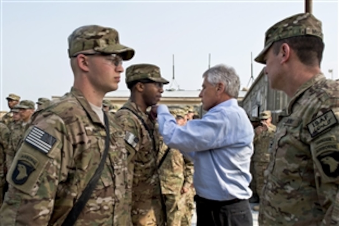 U.S. Defense Secretary Chuck Hagel presents a purple heart to a soldier in Jalalabad, Afghanistan, March 9, 2013. Hagel traveled to Afghanistan on his first trip as the 24th defense secretary to visit U.S. troops, NATO leaders and Afghan counterparts.