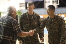 Marines help Guam residents send-off members of the Guam National Guard Feb. 28, at the Yigo Gym during Exercise Guahan Shield. The soldiers with the Guam National Guard are preparing for a deployment to Afghanistan. The Marines are part of exercise Guahan Shield, an exercise designed to facilitate multiservice engagement and provide potential response to theater crises and contingency operations in the Asia-Pacific region.

