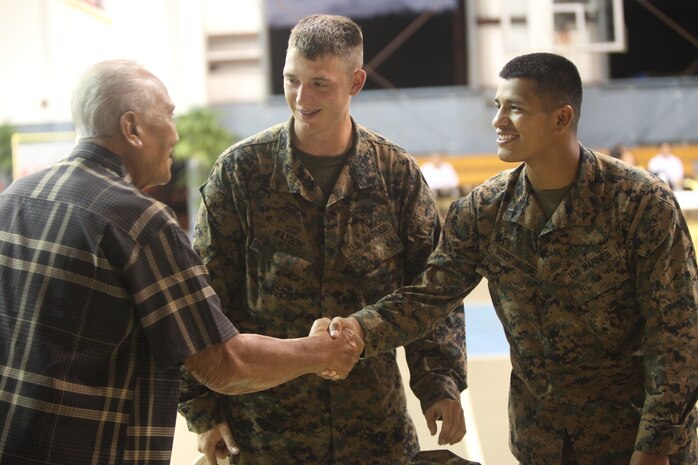 Marines help Guam residents send-off members of the Guam National Guard Feb. 28, at the Yigo Gym during Exercise Guahan Shield. The soldiers with the Guam National Guard are preparing for a deployment to Afghanistan. The Marines are part of exercise Guahan Shield, an exercise designed to facilitate multiservice engagement and provide potential response to theater crises and contingency operations in the Asia-Pacific region.

