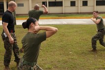 Lance Cpl. Fiona Hoang, part of the forward command element staff for Exercise Guahan Shield, practices Marine Corps Martial Arts Program techniques Feb. 13, 2013, on NCTS, Guam. Exercise Guahan Shield will facilitate multiservice engagements, set conditions for bilateral and multilateral training opportunities, and support rapid response to potential to theater crises and contingency operations in the Asia-Pacific region. The forward command element staff is part of 3rd Marine Logistics Group, III Marine Expeditionary Force.