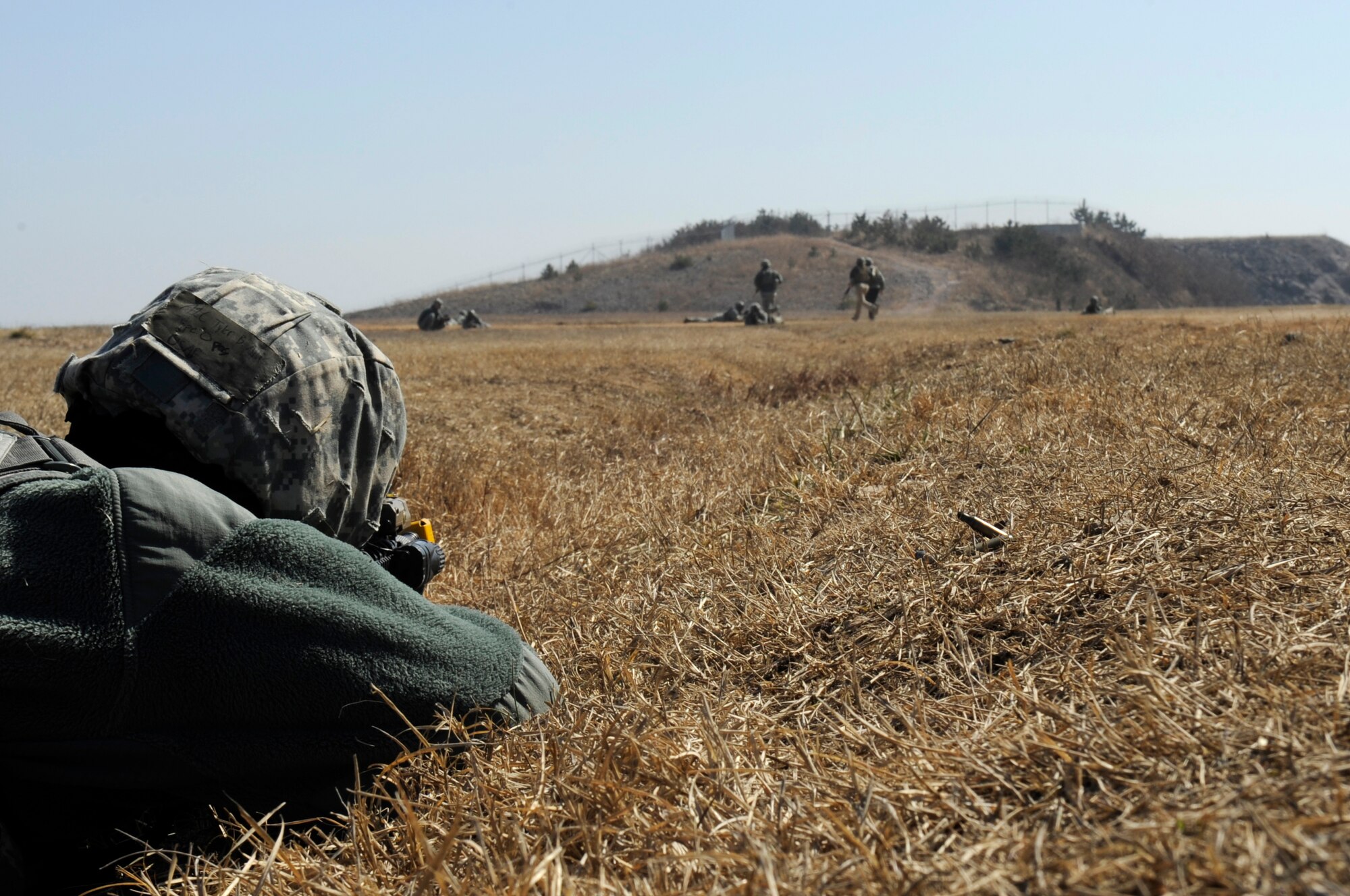 KUNSAN AIR BASE, Republic of Korea – Airman 1st Class Tyler Altis, 8th Security Forces Squadron member, acting as an opposing forces member, fires blank ammunition at a group of 8th SFS and security personnel who were practicing off-base dismounted patrols at Kunsan Air Base, Republic of Korea. (U.S. Air Force photo by Staff Sgt. Tong Duong)