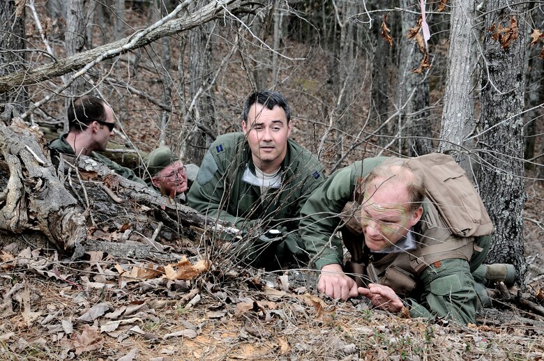 Capt. Mike Adams, center, and other aircrew from the 106th Air Refueling Squadron participate in a Survival, Evasion, Resistance and Escape (SERE) exercise. The purpose of the training is for pilots, boom operators and crew chiefs to know what to do if their aircraft goes down behind enemy lines. (U.S. Air Force photo by 1st Lt. Jonathan Russell) 
