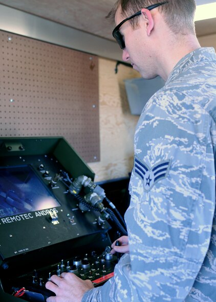 HILL AIR FORCE BASE, Utah -- Senior Airman Tim Zupancic, a 419th EOD technician, operates the controls of a camera-guided, radio-operated robot during a training exercise here Saturday. The high- tech robot allows EOD technicians to disarm explosives from a safe distance. (U.S. Air Force photo/Staff Sgt. Heather Skinkle)