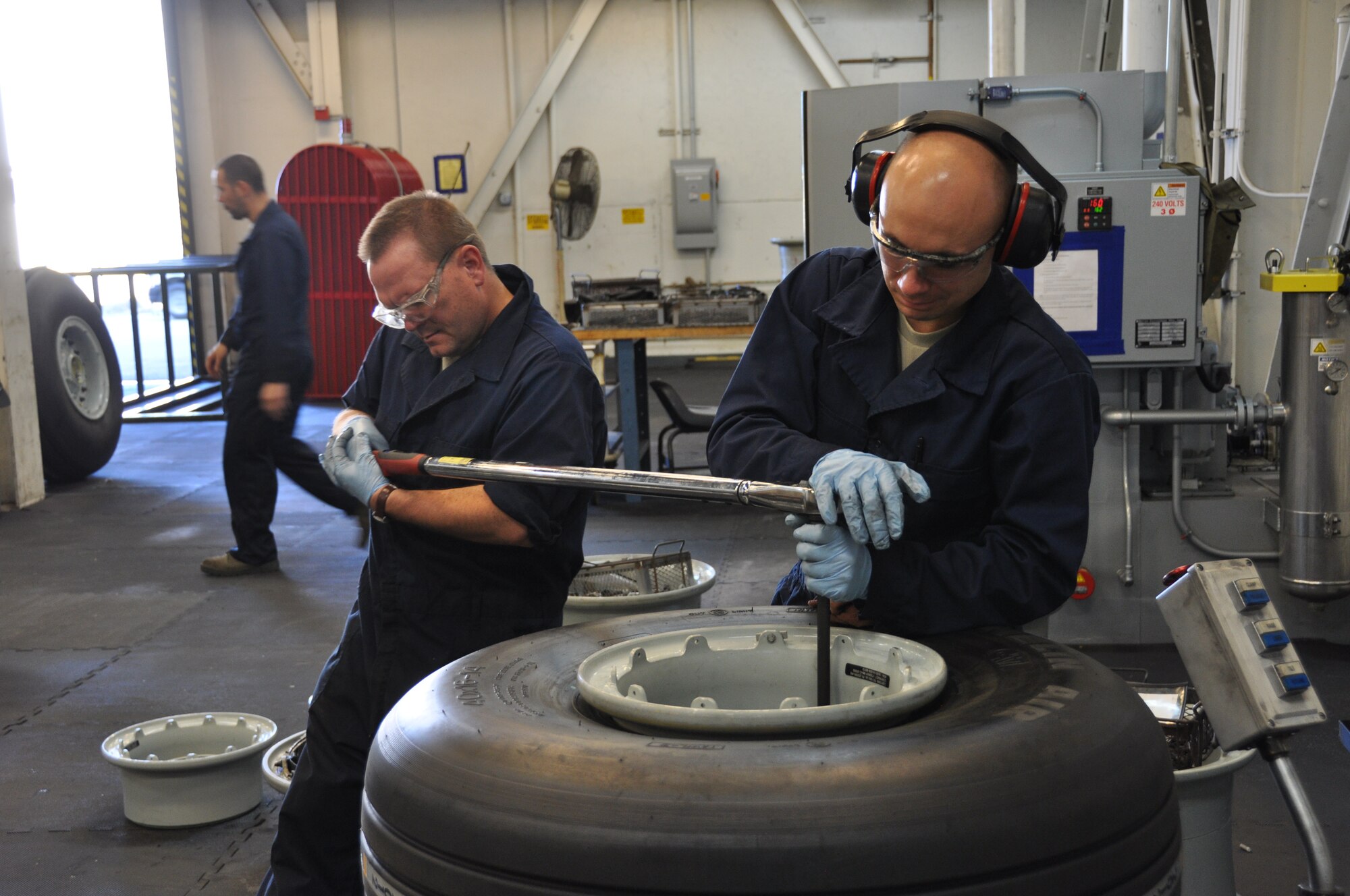 Colonel Samuel Mahaney, 452d Air Mobility Wing commander, performs a final torque on a C-17 NLG Tie Bolts to 162 ft. lbs with Staff Sgt. John Rey, 452d Maintenance Squadron. The wing commander began what he calls a “Dirty Thursday” program where he works along side Airman, getting his hands and clothes dirty.He noted that it’s a great opportunity to know the people who work in the wing as well as a chance to learn what individuals are really doing to support the mission. (U.S. Air Force photo by Master Sgt. Joshua Hornberger)