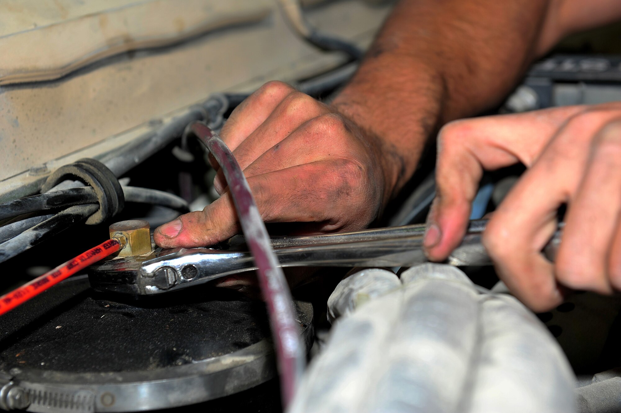 U.S. Air Force Senior Airman Joshua Gandhi, 380th Expeditionary Logistics Readiness Squadron vehicle maintenance journeyman, performs maintenance on a Humvee at an undisclosed location in Southwest Asia Mar. 5, 2013. Less than 50 Airmen maintain a fleet of 900 vehicles and perform servicing and repair on approximately 500 vehicles per month. Gandhi is deployed from Eielson Air Force Base, Alaska. (U.S. Air Force photo by Tech. Sgt. Christina M. Styer/Released) 