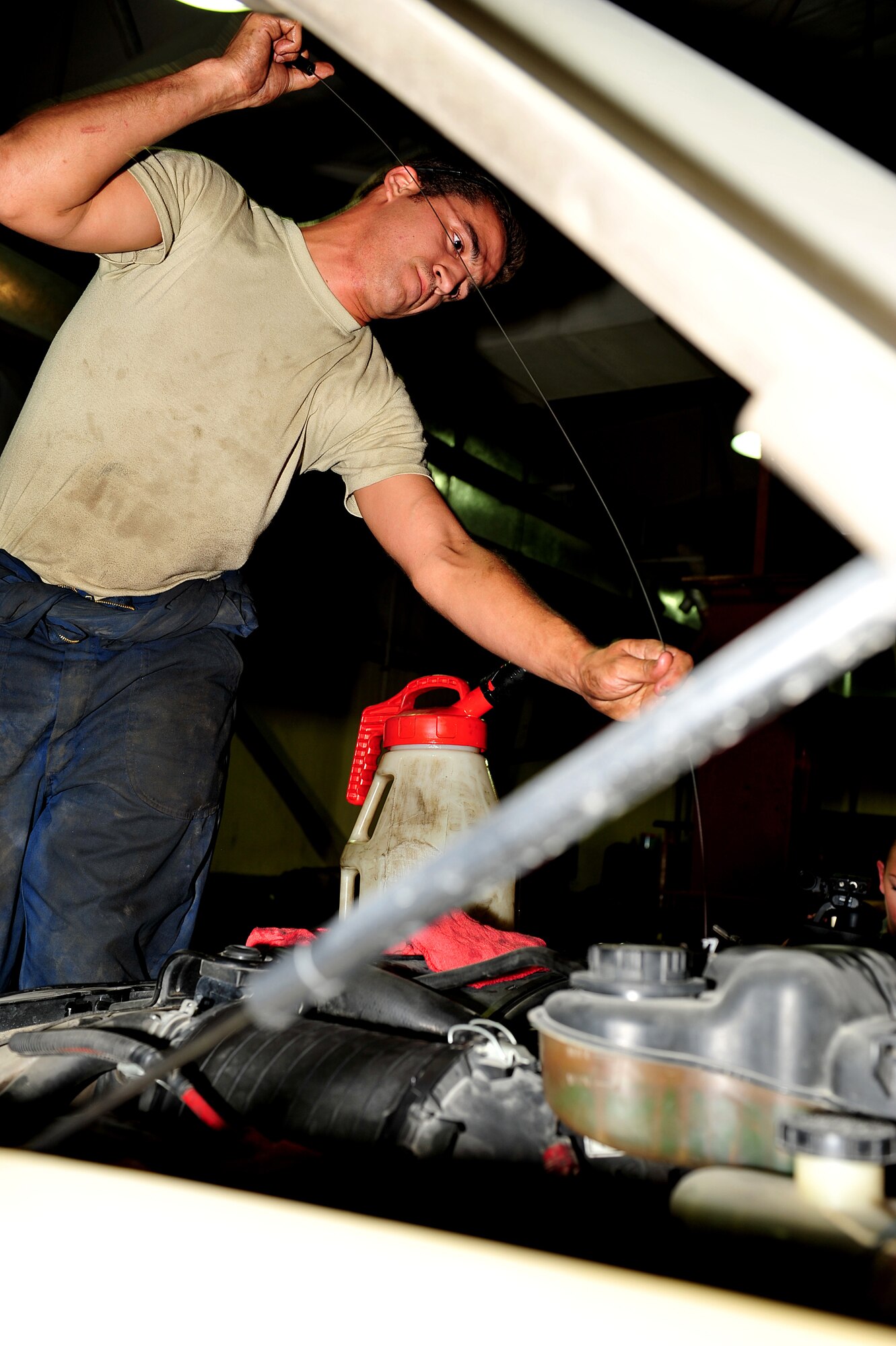U.S. Air Force Staff Sgt. Zakery Rapanaro, 380th Expeditionary Logistics Readiness Squadron vehicle maintenance craftsman, checks the oil in a Ford Bobtail at an undisclosed location in Southwest Asia Mar. 5, 2013. Less than 50 Airmen maintain a fleet of 900 vehicles and perform servicing and repair on approximately 500 vehicles per month. Rapanaro is deployed from Aviano Air Base, Italy. (U.S. Air Force photo by Tech. Sgt. Christina M. Styer/Released) 