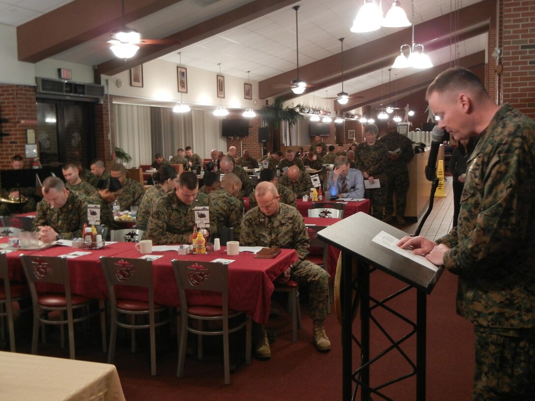 Lt. Cmdr. Robert Burns, Marine and Family Programs Division chaplain, leads a prayer based on the opening lines of the “Our Father” at the National Prayer Breakfast Feb. 12 at Bruce Hall.