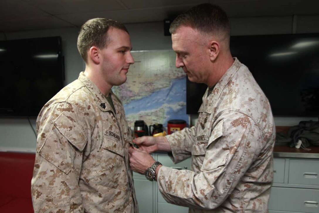 Sergeant Zachary T. Schearer, career planner, Command Element, 15th Marine Expeditionary Unit, receives a Navy and Marine Corps Achievement Medal from Col. Scott D. Campbell, his commanding officer, aboard USS Peleliu, March 6. The 15th MEU is deployed as part of the Peleliu Amphibious Ready Group as a U.S. Central Command theater reserve force, providing support for maritime security operations and theater security cooperation efforts in the U.S. 5th Fleet area of responsibility. Schearer, 22, is from Blandon, Pa. (U.S. Marine Corps photo by Cpl. John Robbart III)