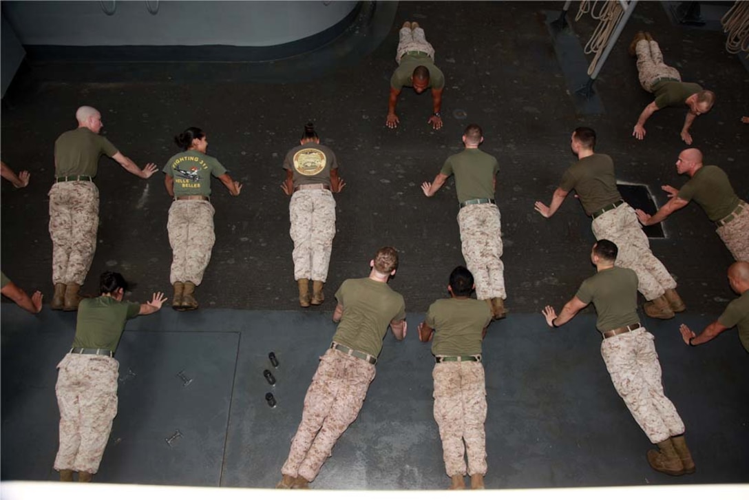 Marines with the 15th Marine Expeditionary Unit participate in a physical training session led by Sgt. Maj. John W. Scott, the unit's sergeant major, as part of Corporals' Course on USS Peleliu, March 8. The 15th MEU is deployed as part of the Peleliu Amphibious Ready Group as a U.S. Central Command theater reserve force, providing support for maritime security operations and theater security cooperation efforts in the U.S. 5th Fleet area of responsibility. (U.S. Marine Corps photo by Cpl. John Robbart III)