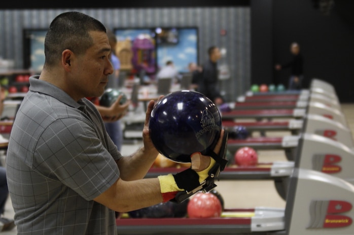 Raul Zepeda, NWO bowler, concentrates as he prepares to place a carefully aimed shot during his final game of the series of the intramural bowling season at the Strike Zone bowling alley here, Feb. 27, 2013. Each team in the intramural bowling season integrated servicemembers from several units who registered to participate. The season officially started Feb. 25, 2013.