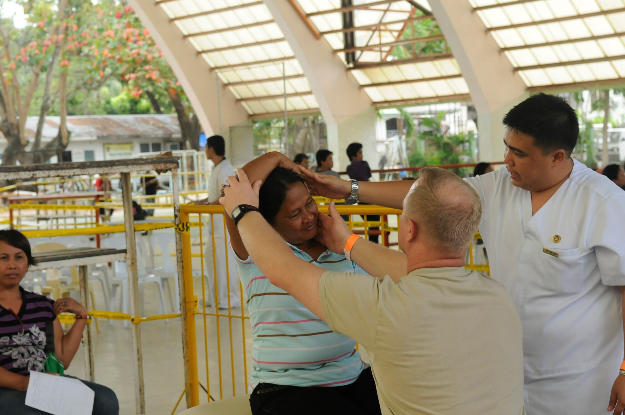 U.S. Air Force Maj. Aaron Fields and a volunteer nurse treat a patient in the primary clinic during an Operation Pacific Angel- Philippines mission at Tanjay, Philippines, on March 6, 2013. The medical teams treated hundreds of patients each day. Fields is a physician from Joint Base Pearl Harbor-Hickam. Operation Pacific Angel is a joint and combined humanitarian assistance mission held in various countries several times a year and includes medical, dental, optometry, engineering programs and various subject-matter expert exchanges. (U.S. Air Force photo/Senior Master Sgt. J.C. Woodring) 
