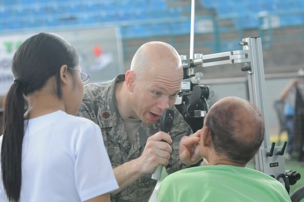 U.S. Air Force Maj. Chad Simpson and a volunteer nurse treat an optometry patient at the Operation Pacific Angel-Philippines medical site at Dumaguete, Philippines March 7, 2013. American and Filipino doctors treated hundreds of patients each day during the mission. Simpson is an optometrist from Misawa Air Base, Japan. Operation Pacific Angel is a joint and combined humanitarian assistance mission held in various countries several times a year and includes medical, dental, optometry, engineering programs and various subject-matter expert exchanges. (U.S. Air Force photo/Senior Master Sgt. J.C. Woodring) 