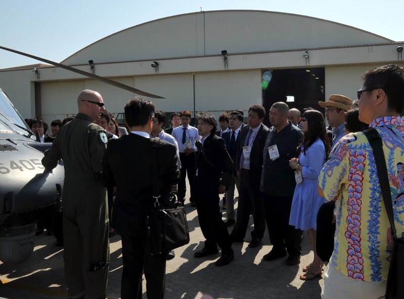 U.S. Air Force Capt. Thomas Beier, 31st Rescue Squadron pilot, tells Japan Youth Chambers of Commerce members about the HH-60G Pave Hawk helicopter during a national convention on Kadena Air Base, Japan, March 8, 2013. The national convention is held every year and the location is rotated among Japan’s 47 prefectures. It’s been more than 30 years since the last convention was held in Okinawa. (U.S. Air Force photo/Naoto Anazawa)