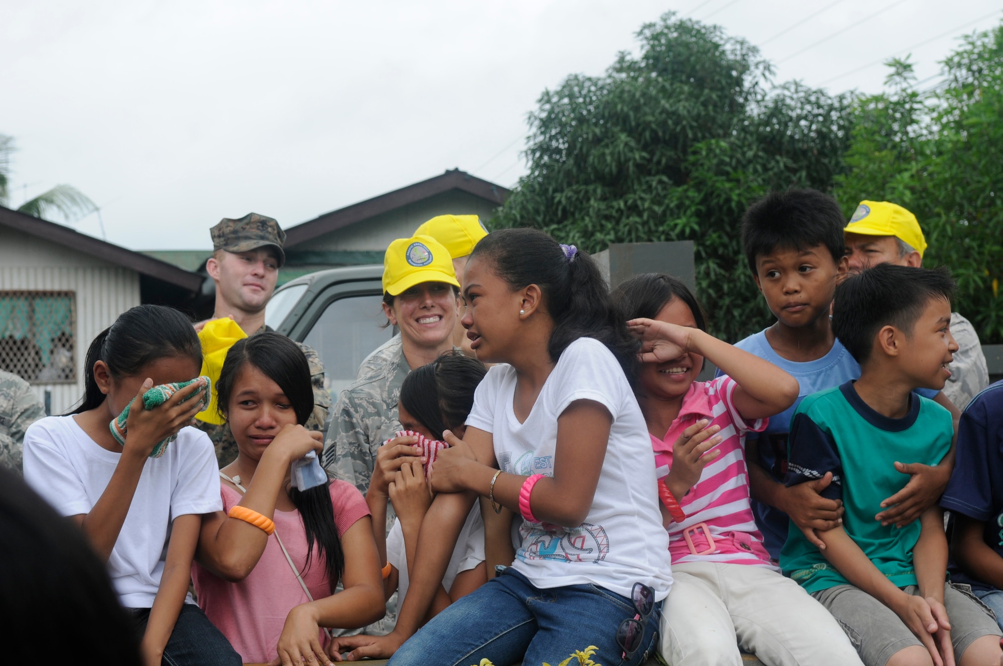 Elementary school students weep as the American and Filipino Operation Pacific Angel-Philippines engineer team leave their school for the last time at Pamplona, Philippines, March 9, 2013. The team of engineers completely renovated a building including electrical, drywall, windows and painting. Operation Pacific Angel is a joint and combined humanitarian assistance exercise held in various countries several times a year and includes medical, dental, optometry, engineering programs and various subject-matter expert exchanges. (U.S. Air Force photo/Senior Master Sgt. J.C. Woodring)
