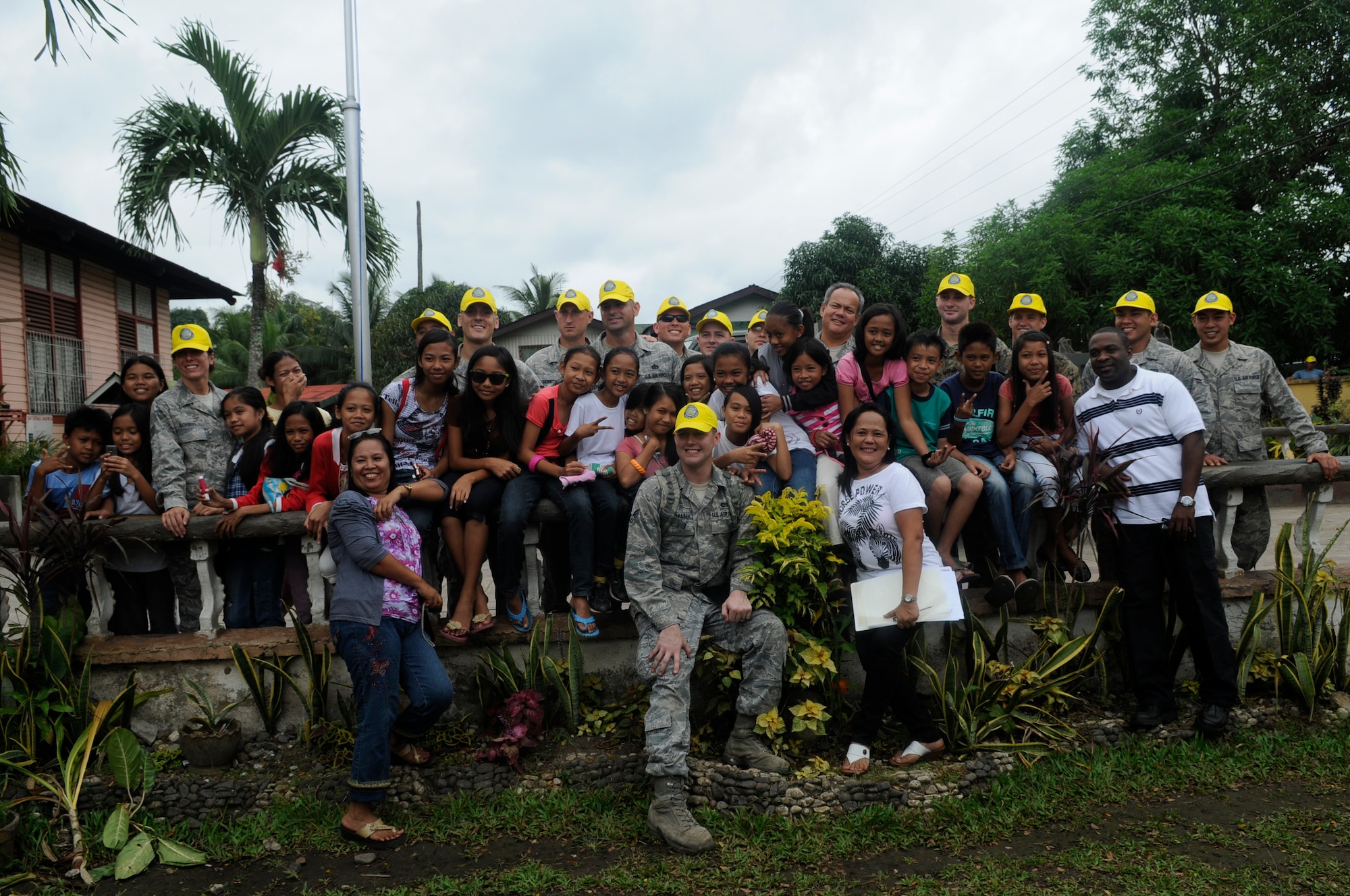 A team of American and Filipino Operation Pacific Angel-Philippines engineers joined school teachers and students for a group photo at Pamplona, Philippines, March 9, 2013. The engineers completely renovated a building including electrical, drywall, windows and painting. Operation Pacific Angel is a joint and combined humanitarian assistance exercise held in various countries several times a year and includes medical, dental, optometry, engineering programs and various subject-matter expert exchanges. (U.S. Air Force photo/Senior Master Sgt. J.C. Woodring)