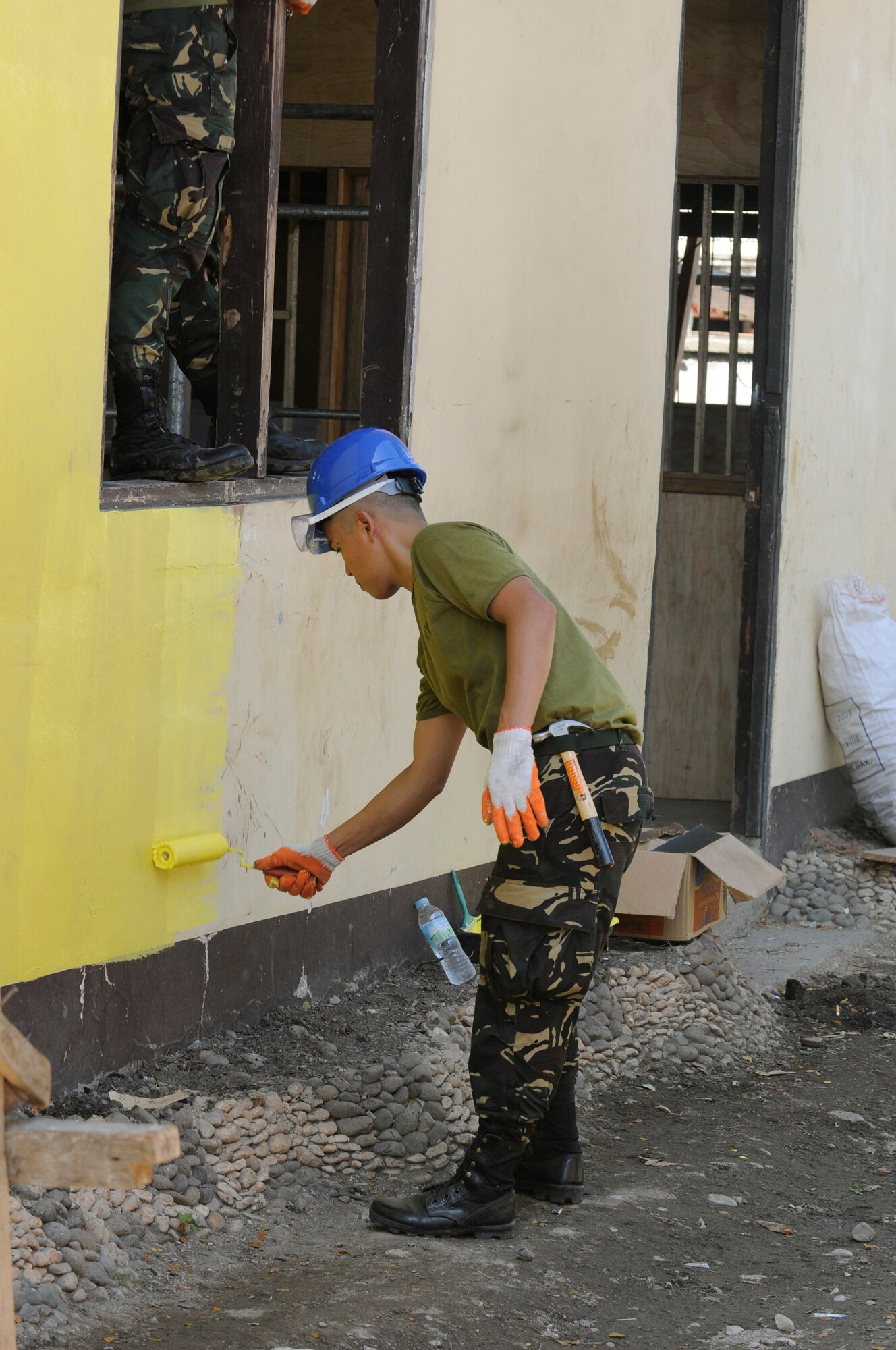 Armed Forces of the Philippines Staff Sgt. Talento begins a building renovation as part of a team of American and Filipino Operation Pacific Angel-Philippines engineers at an elementary school in Pamplona, Philippines, March 3, 2013. The renovations included electrical, drywall, windows and painting. Operation Pacific Angel is a joint and combined humanitarian assistance exercise held in various countries several times a year and includes medical, dental, optometry, engineering programs and various subject-matter expert exchanges. (U.S. Air Force photo/Senior Master Sgt. J.C. Woodring)

