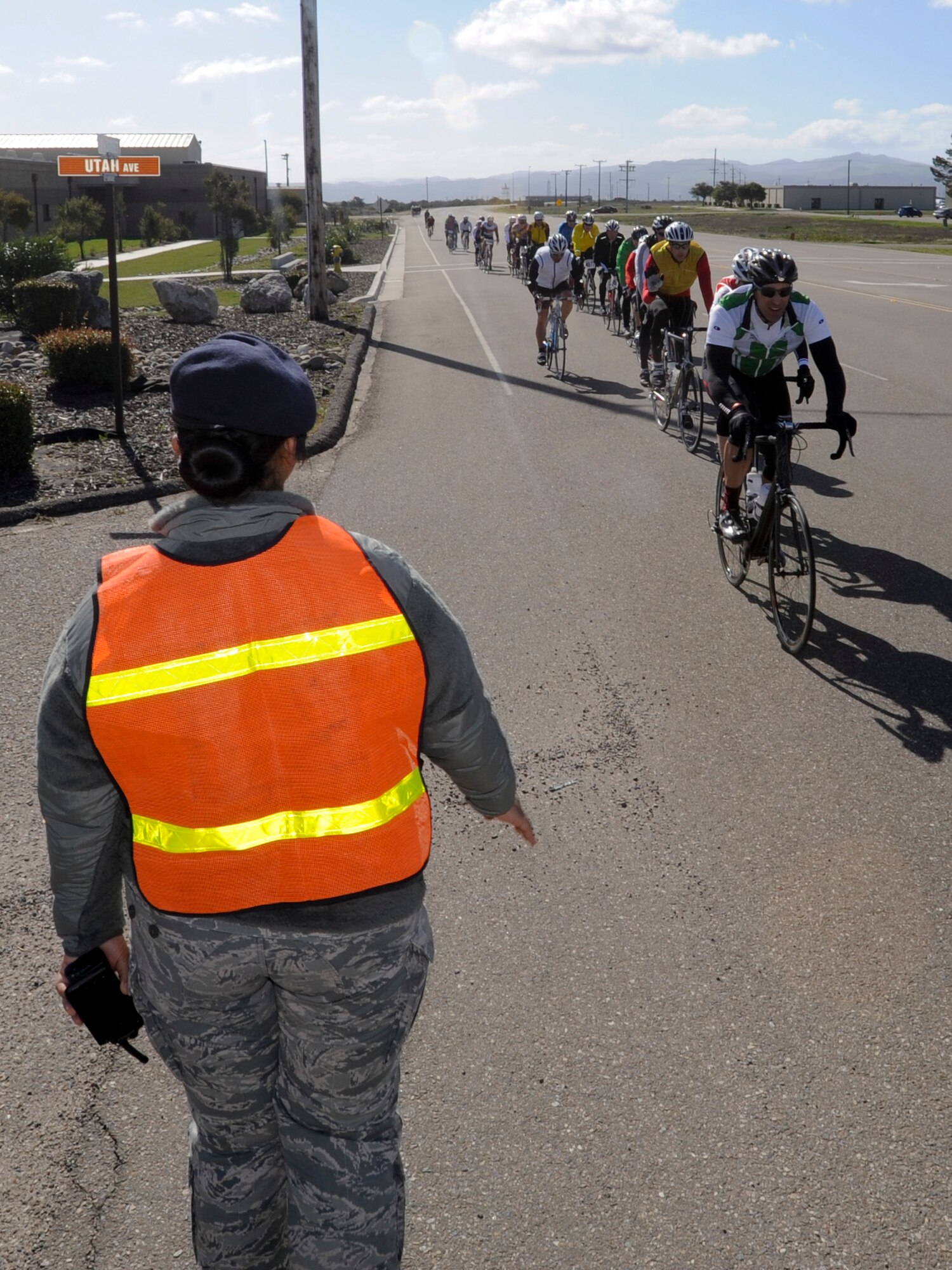 VANDENBERG AIR FORCE BASE, Calif. – Airman 1st Class Veronika Ransfer, 30th Security Forces Squadron, greets riders passing through Vandenberg here Saturday, March 9, 2013. Nearly 1,500 riders participated in a 100-mile century ride, 14 of those miles through Vandenberg Air Force Base. (U.S. Air Force photo/Airman Yvonne Morales)