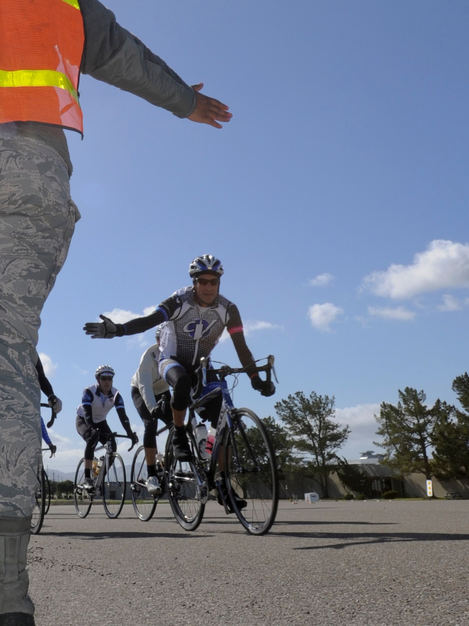 VANDENBERG AIR FORCE BASE, Calif. – A biker with the Specialized Coronary Outpatient Rehabilitation Cardiac Cyclist Club Inc. gives a high five while passing through Vandenberg here Saturday, March 9, 2013. Nearly 1,500 riders participated in a 100-mile century ride, 14 of those miles through Vandenberg Air Force Base. (U.S. Air Force photo/Airman Yvonne Morales)