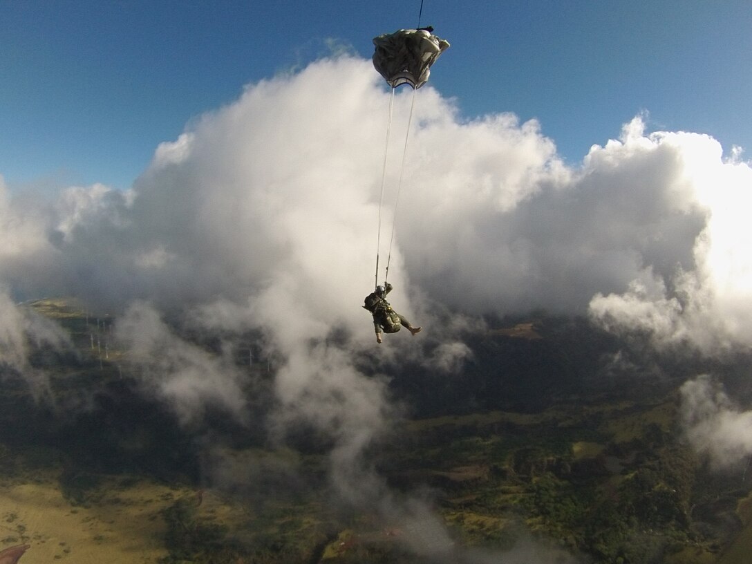 Maj. Aaron Lawson jumps from a C-17 Globemaster III Feb. 26, 2013, near Joint Base Pearl Harbor Hickam-Hawaii. The jump was filmed by veteran freefall cameraman and skydiver cinematographer, Tom Sanders, and will be used in a scene on an upcoming episode of the television show “Hawaii Five-0.” Lawson was given the opportunity to serve as a stunt double for actor Alex O’Loughlin, who plays Steve McGarrett on the show and will be featured alongside Marine Corps Staff Sgt. John Phillips, SOCPAC jumper and parachute rigger, performing the freefall jump. This episode will air April 15 on CBS at 10PM EST. Lawson is a Special Operations Command, Pacific jumper and special tactics officer.  (Photo/Tom Sanders)
