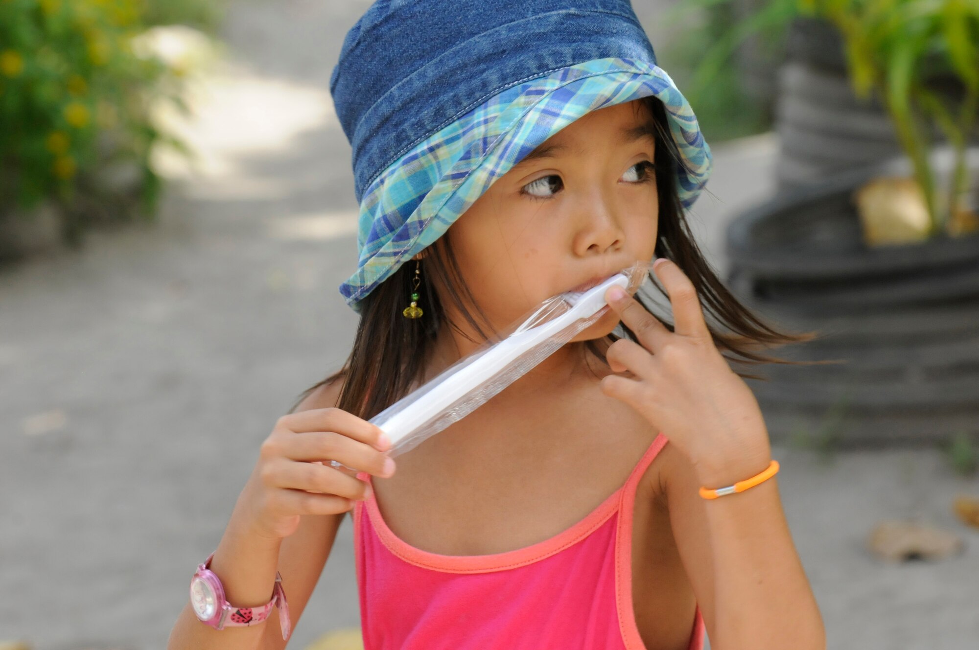 An elementary student checks out her toothbrush given to her during an Operation Pacific Angel-Philippines subject-matter expert exchange held in Dumaguete, Philippines, March 7, 2013. The dental technicians team visited the school to teach dental hygiene. Operation Pacific Angel is a joint and combined humanitarian assistance exercise held in various countries several times a year and includes medical, dental, optometry, engineering programs and various subject-matter expert exchanges. (U.S. Air Force photo/Senior Master Sgt. J.C. Woodring) 
