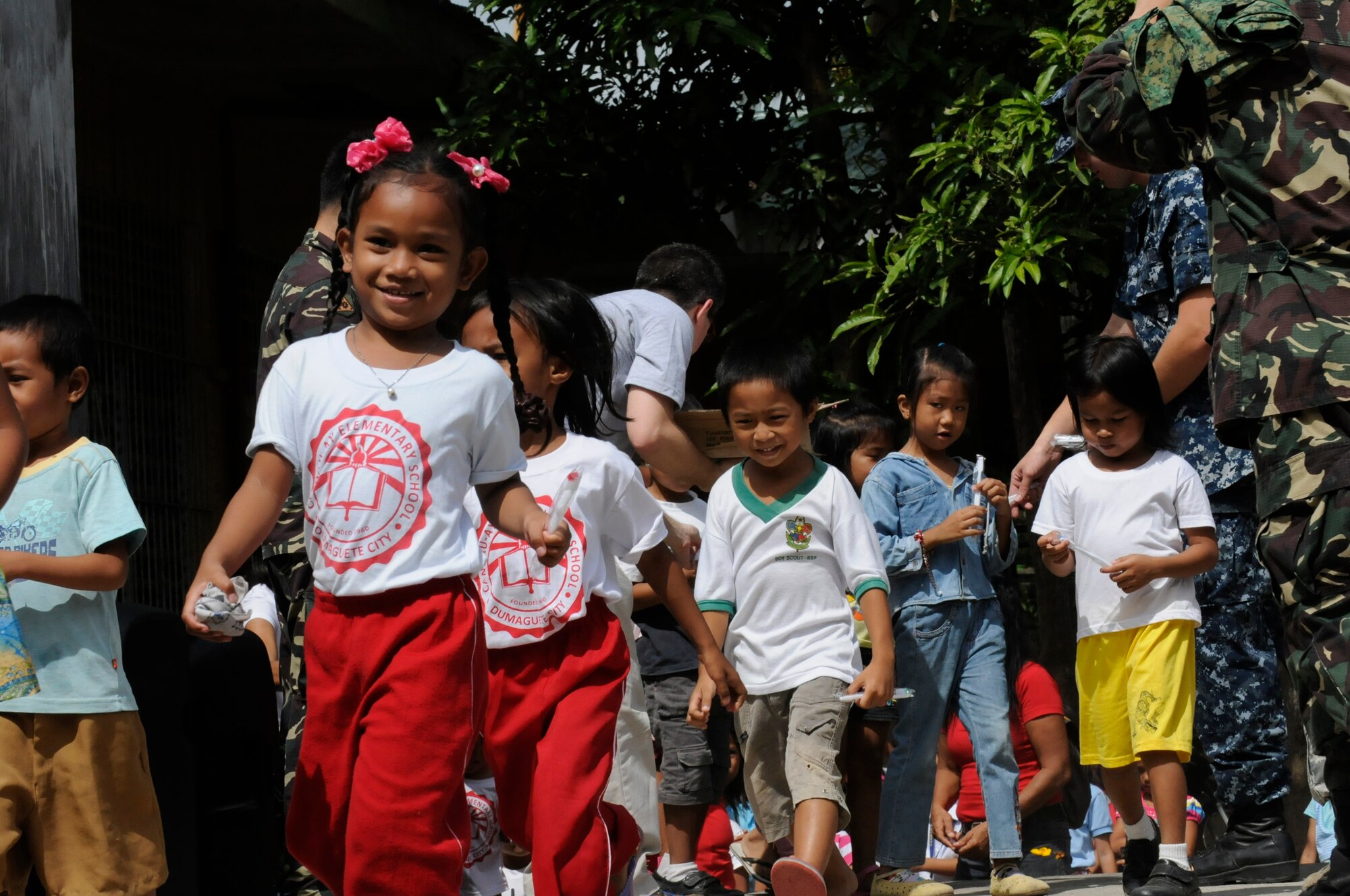 Elementary students receive toothbrushes during an Operation Pacific Angel-Philippines subject-matter expert exchange held in Dumaguete, Philippines, March 7, 2013. The dental technicians team visited the school to teach dental hygiene. Operation Pacific Angel is a joint and combined humanitarian assistance exercise held in various countries several times a year and includes medical, dental, optometry, engineering programs and various subject-matter expert exchanges. (U.S. Air Force photo/Senior Master Sgt. J.C. Woodring)