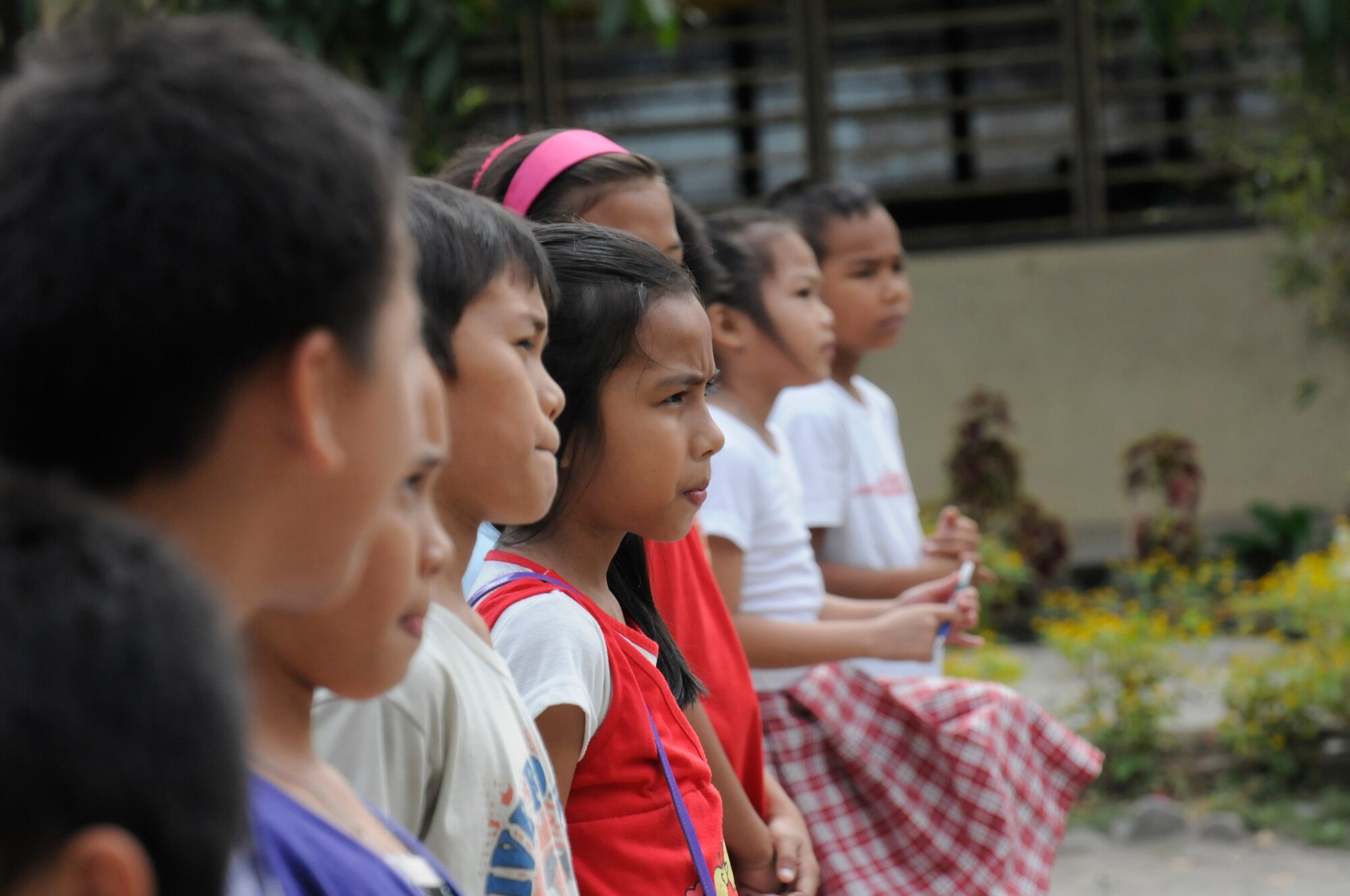 Elementary students wait for a team of Operation Pacific Angel-Philippines dental technicians to teach them about oral hygiene in Dumaguete, Philippines, March 7, 2013. This was one subject matter expert exchange held during the mission. Operation Pacific Angel is a joint and combined humanitarian assistance exercise held in various countries several times a year and includes medical, dental, optometry, engineering programs and various subject-matter expert exchanges. (U.S. Air Force photo/Senior Master Sgt. J.C. Woodring)