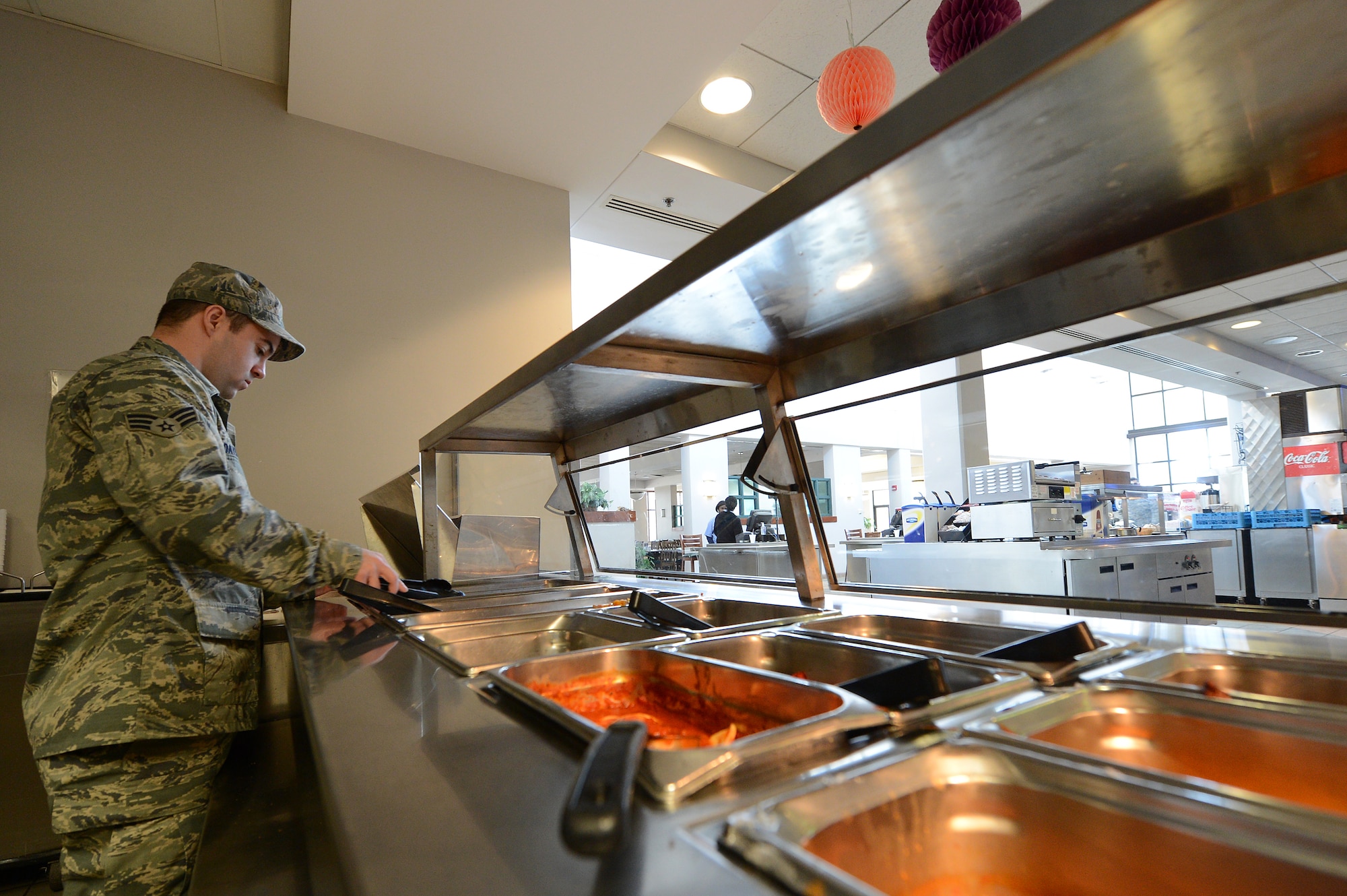 U.S. Air Force Senior Airman Matthew Davenport, 20th Force Support Squadron food service specialist, performs a temperature check on the food at the Chief Emerson dining facility, Shaw Air Force Base, S.C., March 6, 2013.  Once cooked, all beef and poultry must be kept at a temperature of at least 165 degrees and fish can be kept at 155 degrees.  Vegetables and starchy foods cannot be less than 140 degrees. (U.S. Air Force photo by Airman 1st Class Nicole Sikorski/Released)