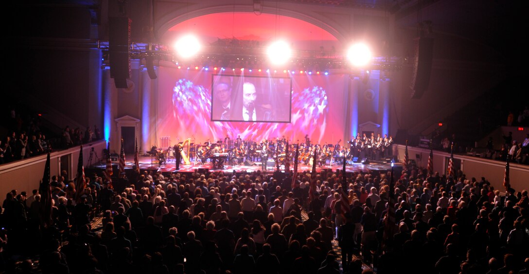 Singing his hit "God Bless the USA," Grammy Award winner Lee Greenwood, along with a U.S. Air Force Honor Guard flag processional, bring the Guest Artist Series performance at DAR Constitution Hall in Washington, D.C. to a close March 10. Greenwood was the final guest artist to be featured in the 2013 Air Force Band's Guest Artist Series. (U.S. Air Force photo/Senior Airman Lindsey A. Porter)
