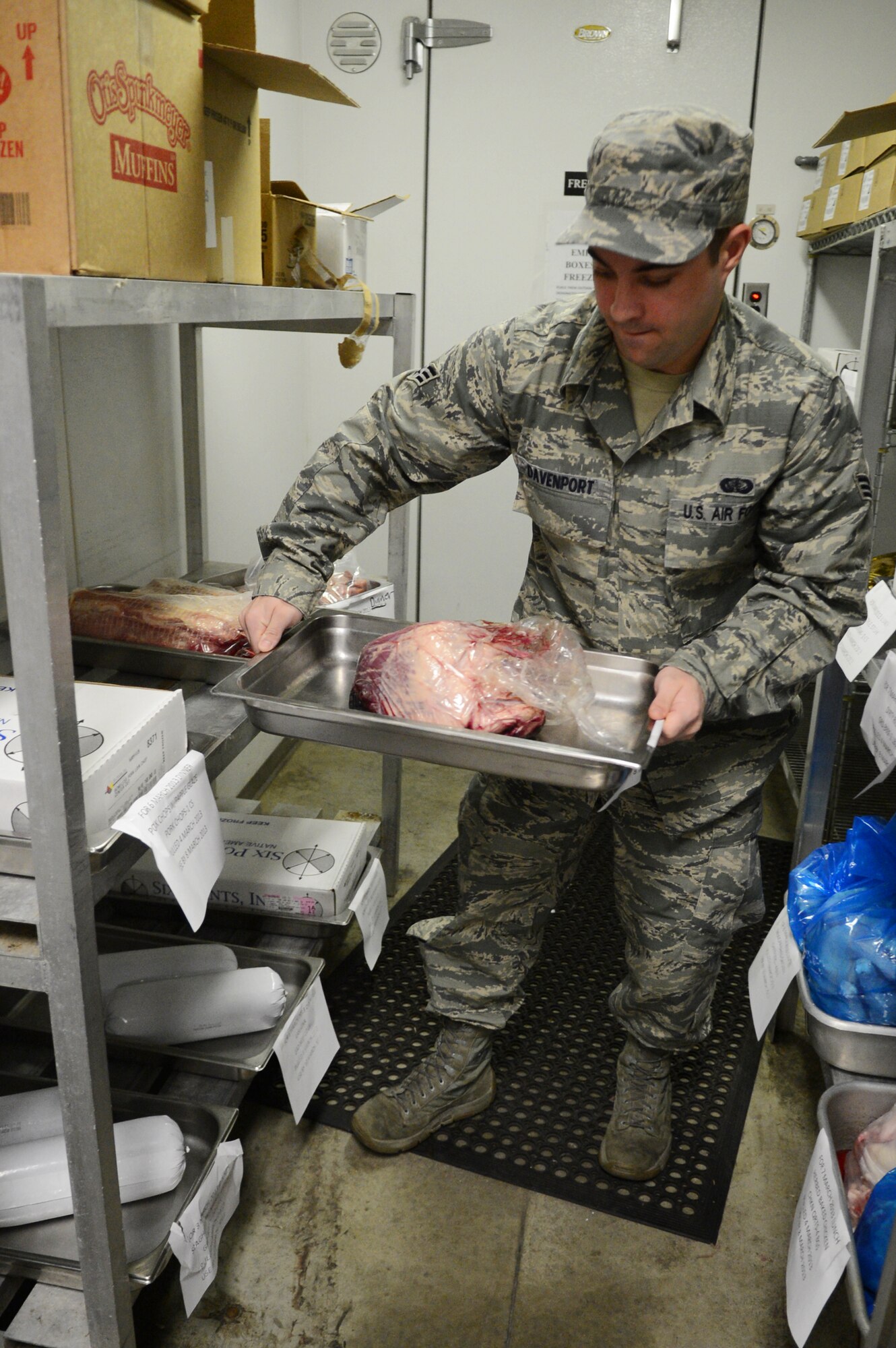 U.S. Air Force Senior Airman Matthew Davenport, 20th Force Support Squadron food service specialist gets beef out of the storeroom at the Chief Emerson dining facility, Shaw Air Force Base, S.C., March 6, 2013.  To keep food safe, in the storeroom, Airmen make sure the floor is always clean, no food is spoiled,  shelves are stocked free of dust and food particles, no signs of insects or rodents,  that all food is stored at least six inches above the floor and that foods are properly thawed and labeled.  (U.S. Air Force photo by Airman 1st Class Nicole Sikorski/Released)