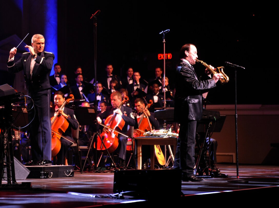 With Col. Larry Lang, U.S. Air Force Band commander, conducting, Lee Greenwood, 1983 Academy of Country Music Male Vocalist of the Year, plays saxophone during his set at DAR Constitution Hall in Washington, D.C. March 10, 2013. Other artists highlighted during this year's series included Melina Leon and The Rogues. (U.S. Air Force photo/Senior Airman Lindsey A. Porter)