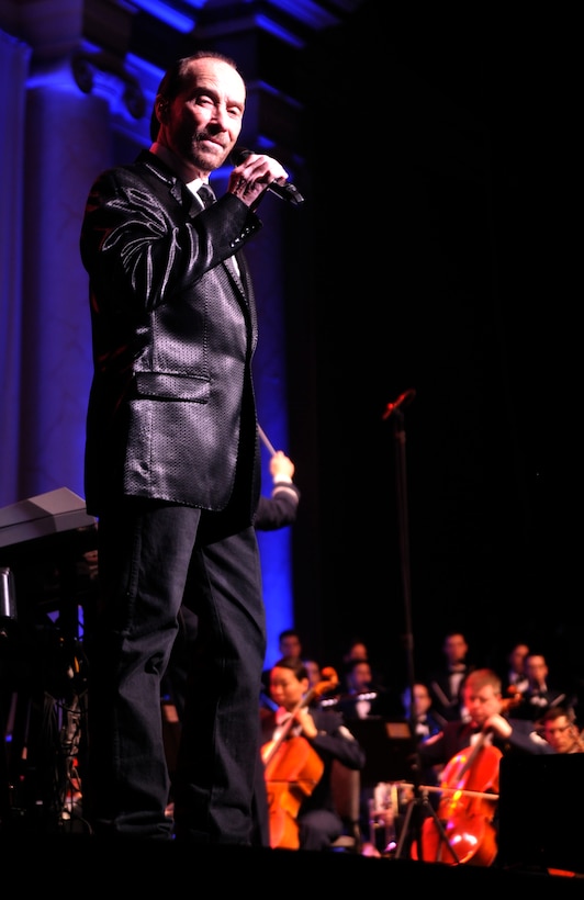 Lee Greenwood, Grammy Award winner and two-time Country Music Association Male Vocalist of the Year, performs for fans March 10, 2013 alongside the U.S. Air Force Band and Singing Sergeants during the final 2013 Guest Artist Series performance at DAR Constitution Hall in Washington, D.C. Greenwood is best known for his three-time number-one hit, “God Bless the USA.”  (U.S. Air Force photo/Senior Airman Lindsey A. Porter)