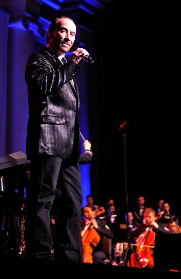 Lee Greenwood, Grammy Award winner and two-time Country Music Association Male Vocalist of the Year, performs for fans March 10, 2013 alongside the U.S. Air Force Band and Singing Sergeants during the final 2013 Guest Artist Series performance at DAR Constitution Hall in Washington, D.C. Greenwood is best known for his three-time number-one hit, “God Bless the USA.”  (U.S. Air Force photo/Senior Airman Lindsey A. Porter)