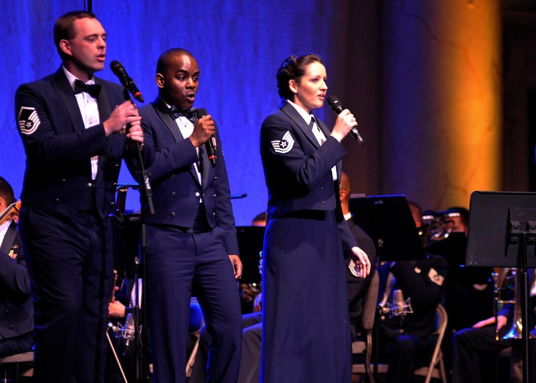 From left to right, Master Sgt. Eric Sullivan, Tech. Sgt. Aaron Paige and Tech. Sgt. Emily Barnes, members of the Air Force’s Singing Sergeants, perform during the first half a 2013 Guest Artist Series event March 10, 2013 at DAR Constitution Hall in Washington, D.C. The second half of the show included songs performed by the U.S. Air Force Band and Grammy Award winner Lee Greenwood. (U.S. Air Force photo/Senior Airman Lindsey A. Porter)