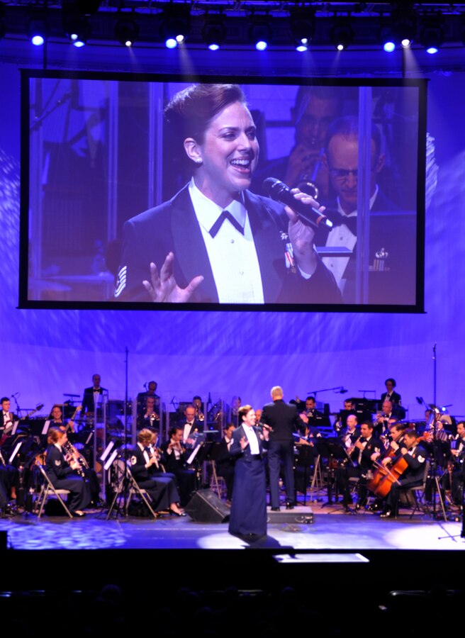 Tech. Sgt. Julia Brundage, member of the U.S. Air Force Band’s Singing Sergeants, performs a song by country music artist Sara Evans March 10, 2013, at DAR Constitution Hall in Washington, D.C. The performance was part of the Air Force Band’s 2013 Guest Artist Series which highlights entertainers of national and international renown who perform alongside the Air Force’s premiere musical ensemble.  (U.S. Air Force photo/Senior Airman Lindsey A. Porter)