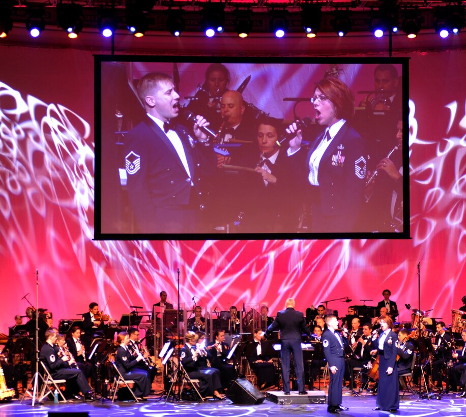 Master Sgt. Ryan Dolan, left, and Senior Master Sgt. Christine Germain, members of the U.S. Air Force’s Singing Sergeants, perform a duet during the final installment of the Air Force Band’s 2013 Guest Artist Series March 10, 2013, at DAR Constitution Hall in Washington, D.C. The Guest Artist Series began in 1966 and has evolved to feature entertainers of national and international renown who perform alongside the Air Force Band. (U.S. Air Force photo/Senior Airman Lindsey A. Porter)